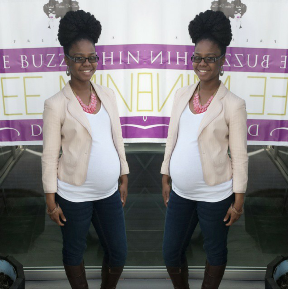 pregnant black woman in white maternity top and pink blazer