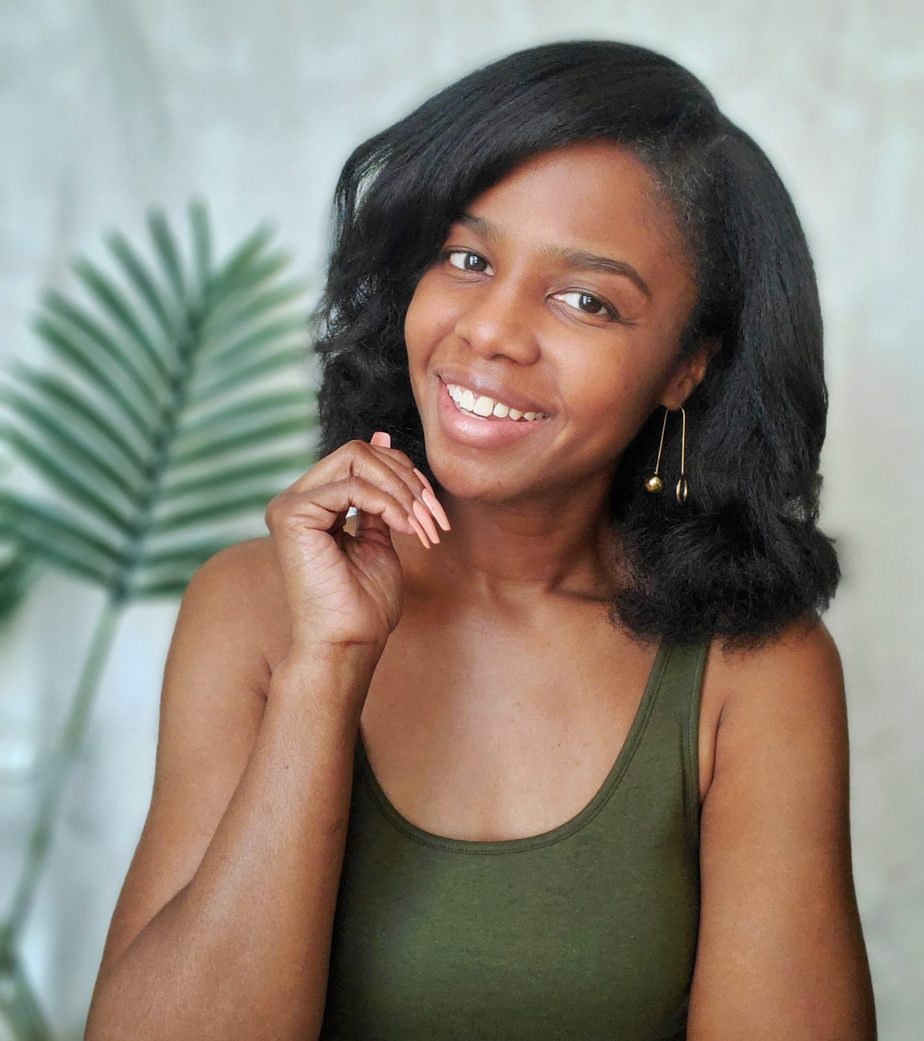 straightened 4c kinky hair blown out and curled white background with plant