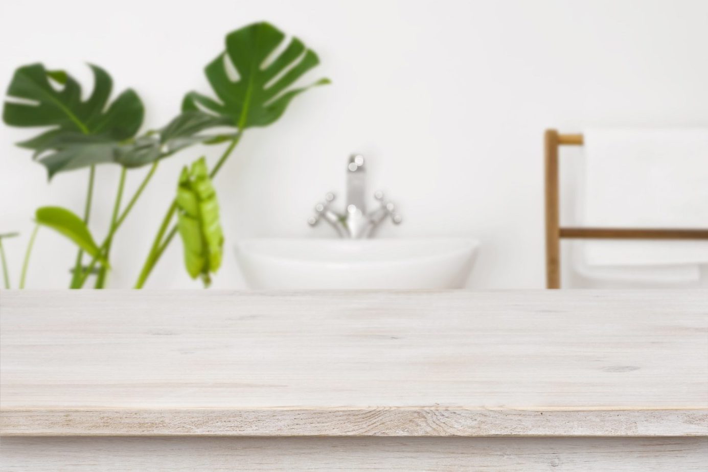 Wooden table top for product display over blurred bathroom inter